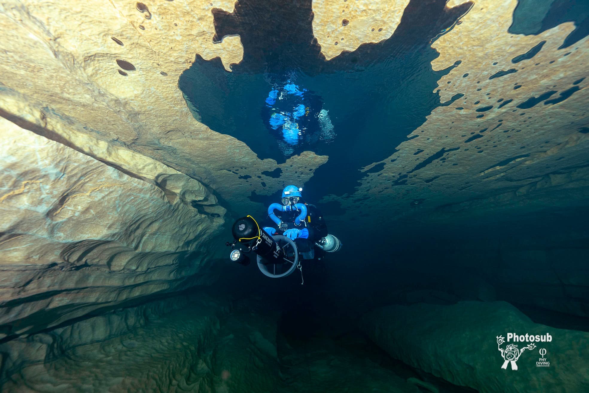 Diver in horizontal trim operating a diver propulsion vehicle in a flooded cavern